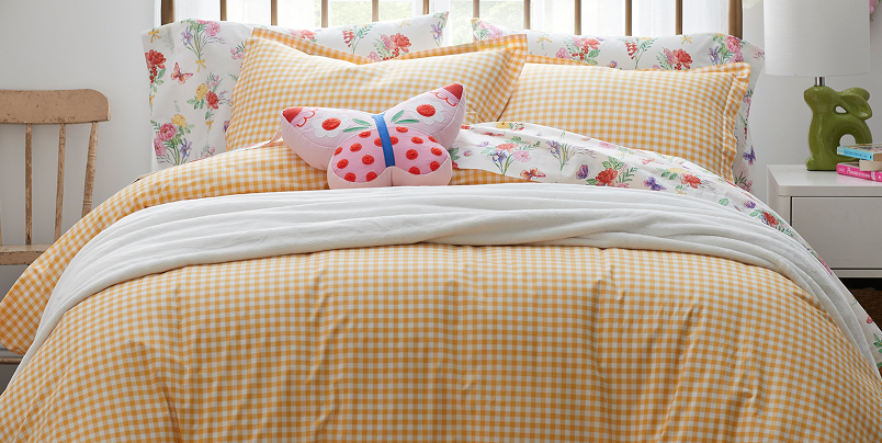 Image of bed with yellow gingham checked bedding